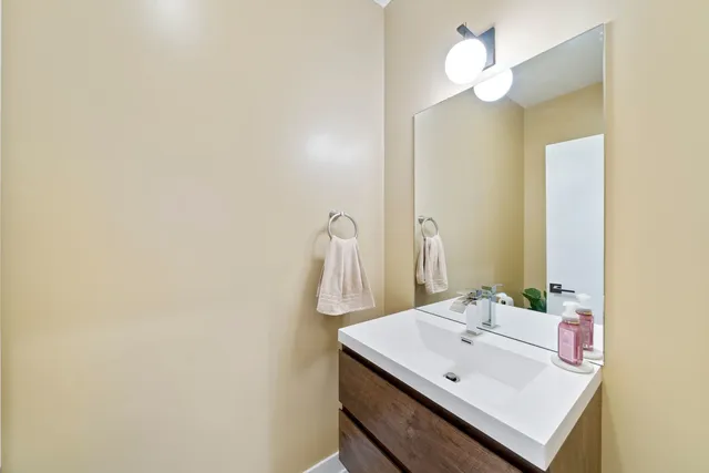 a bathroom with a sink a mirror and a light fixture