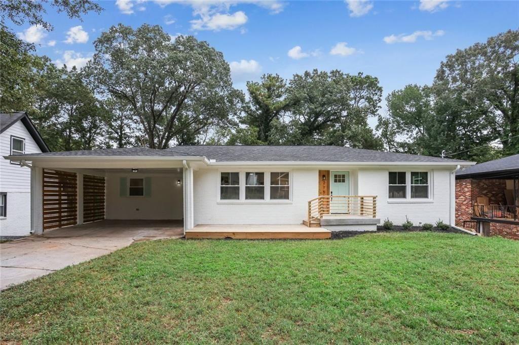 a front view of house with yard and outdoor seating