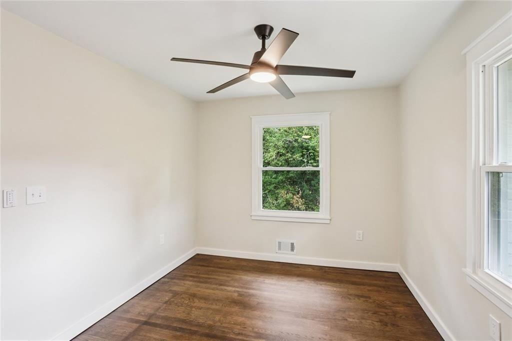 2152 Edgemore Drive Southeast Atlanta, GA 30316 - Photo 18 of 33 an empty room with wooden floor ceiling fan and windows