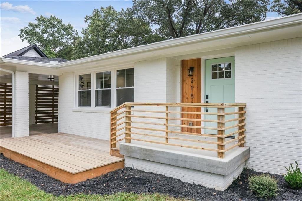 2152 Edgemore Drive Southeast Atlanta, GA 30316 - Photo 2 of 33 a view of a white house with a large window and flower plants