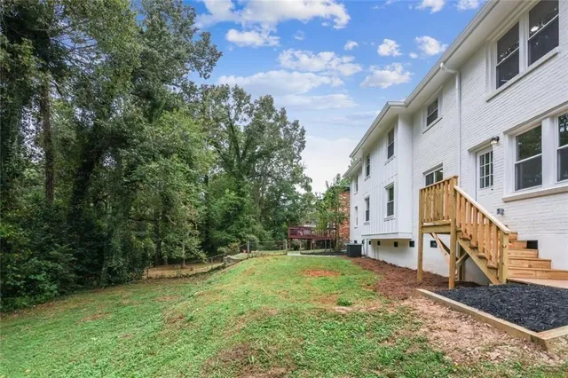 a backyard of a house with lots of green space