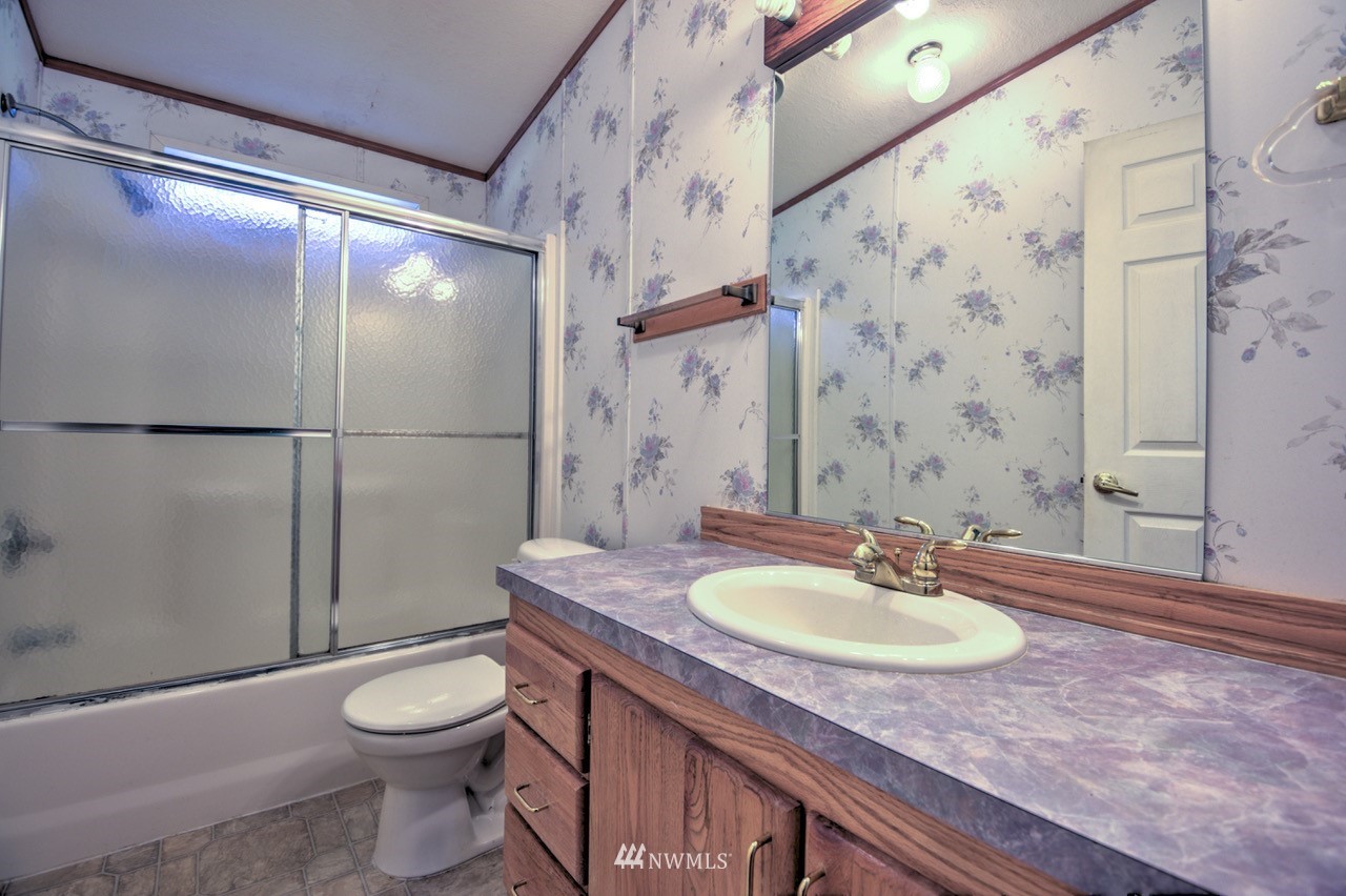 17327 Sargent Road Southwest Rochester, WA 98579 - Photo 14 of 23 a bathroom with a granite countertop sink toilet and shower