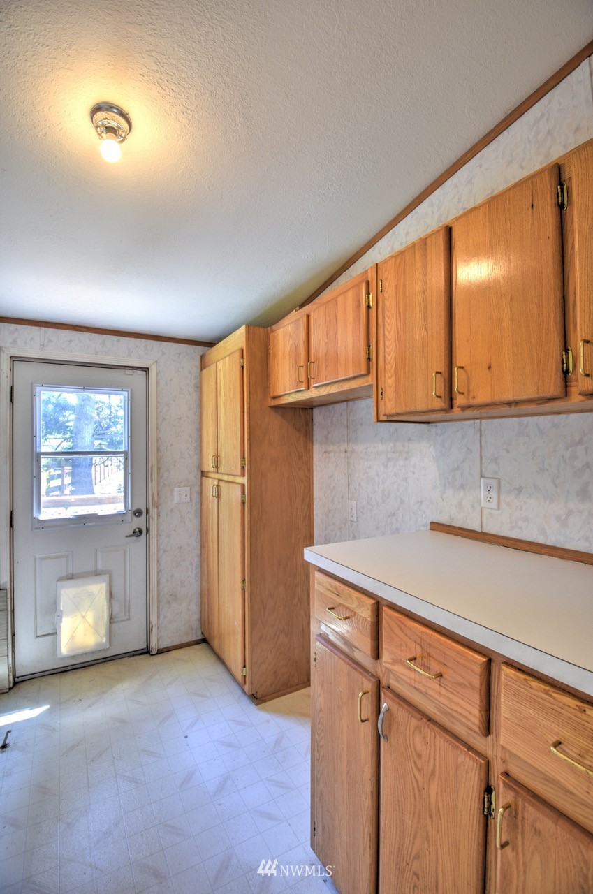 17327 Sargent Road Southwest Rochester, WA 98579 - Photo 16 of 23 a view of a kitchen with furniture and a window