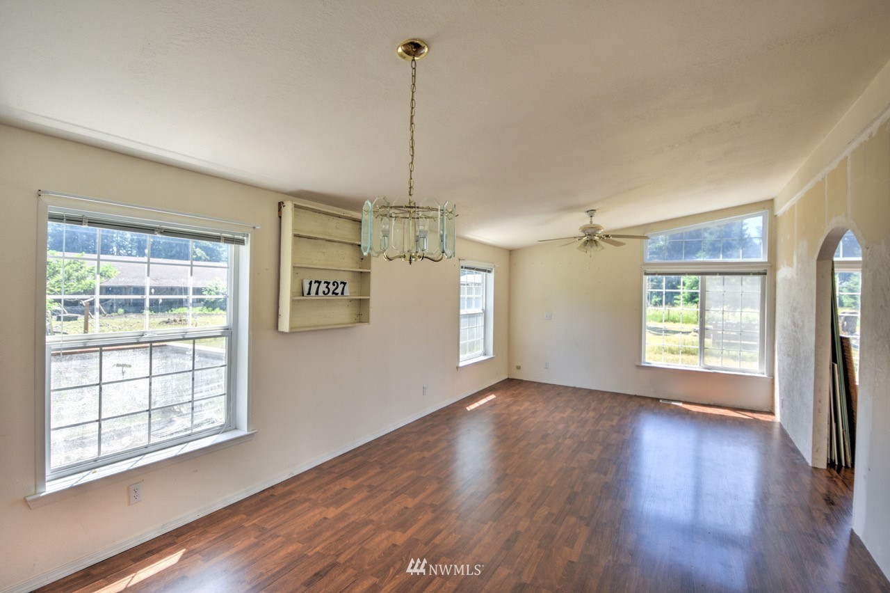 17327 Sargent Road Southwest Rochester, WA 98579 - Photo 17 of 23 a view of an empty room with wooden floor and a window