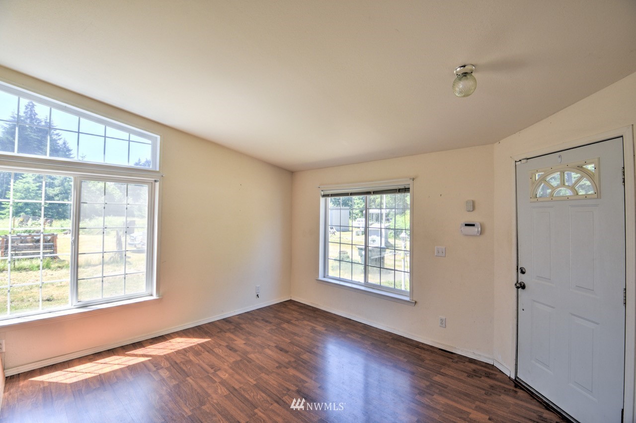 17327 Sargent Road Southwest Rochester, WA 98579 - Photo 19 of 23 an empty room with wooden floor and windows