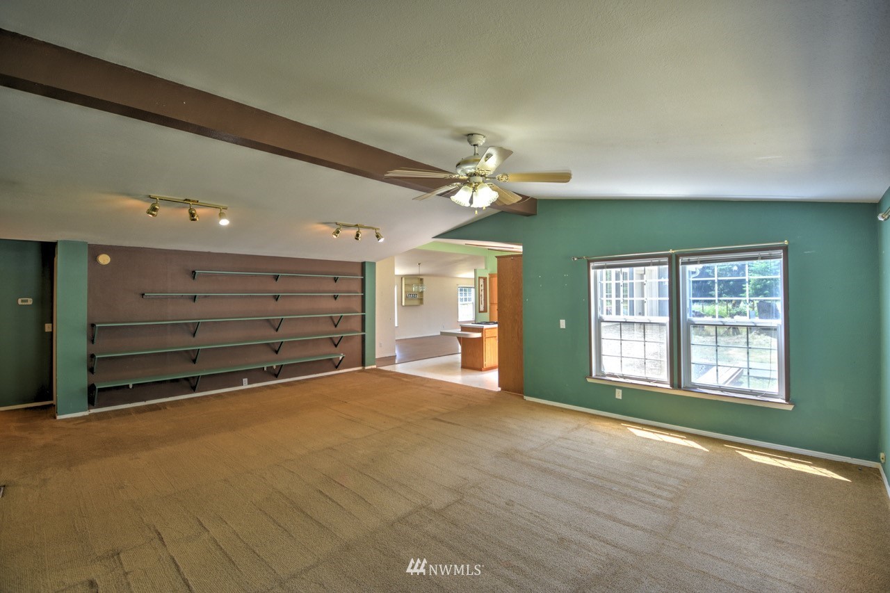17327 Sargent Road Southwest Rochester, WA 98579 - Photo 4 of 23 a view of an empty room with a window and fireplace