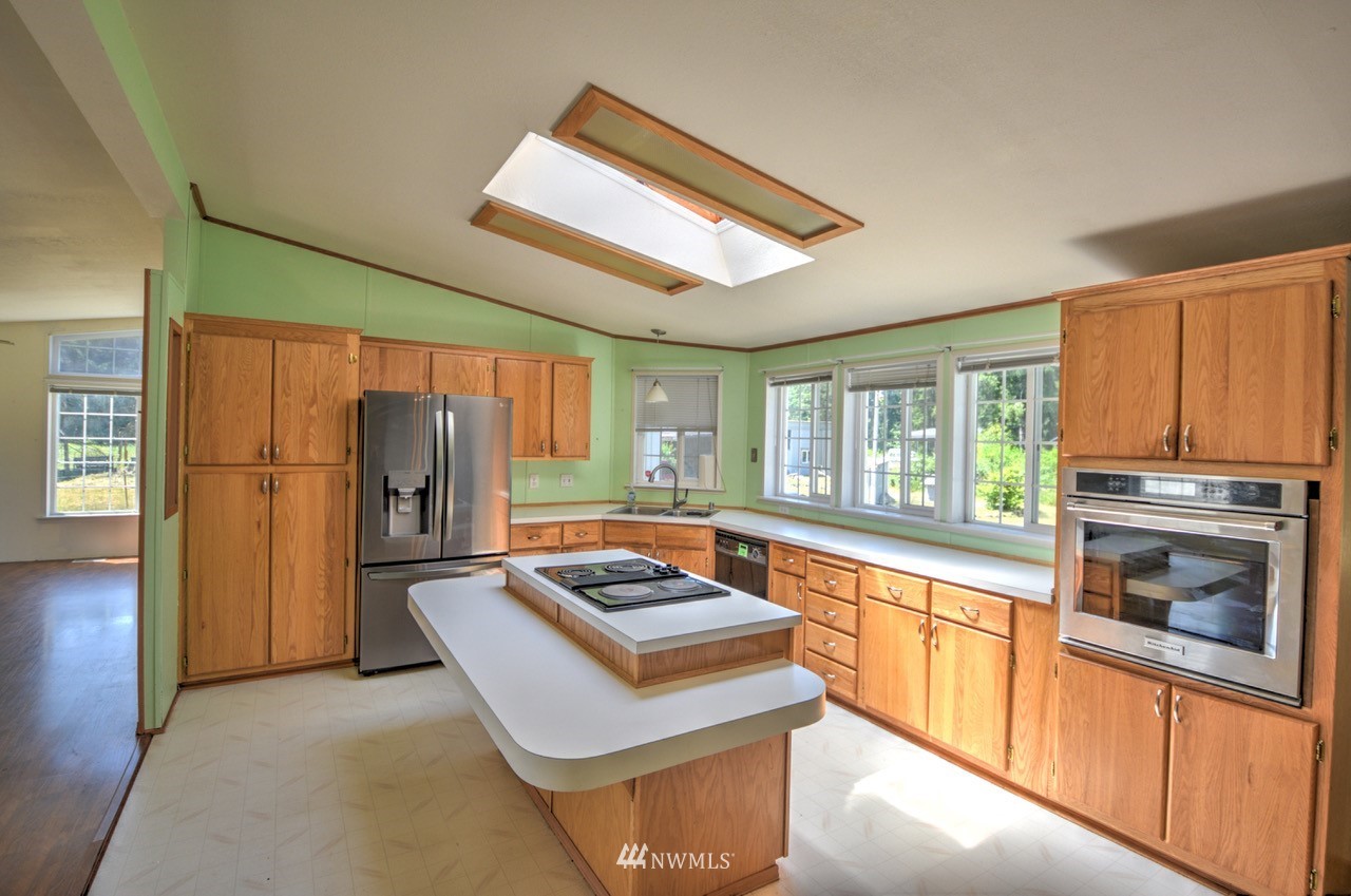 17327 Sargent Road Southwest Rochester, WA 98579 - Photo 5 of 23 a kitchen with refrigerator and stove