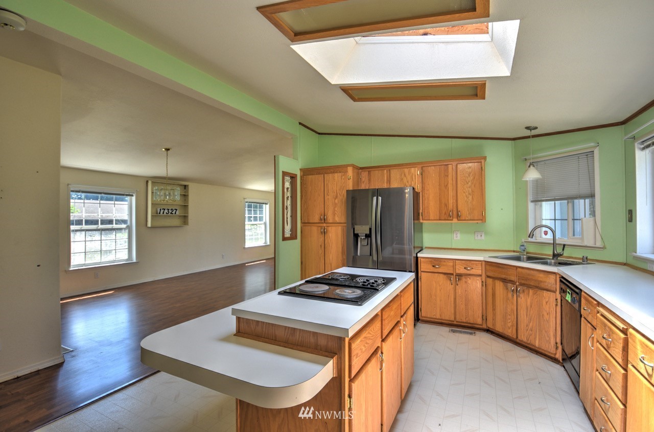 17327 Sargent Road Southwest Rochester, WA 98579 - Photo 7 of 23 a kitchen with stainless steel appliances granite countertop a sink stove and refrigerator