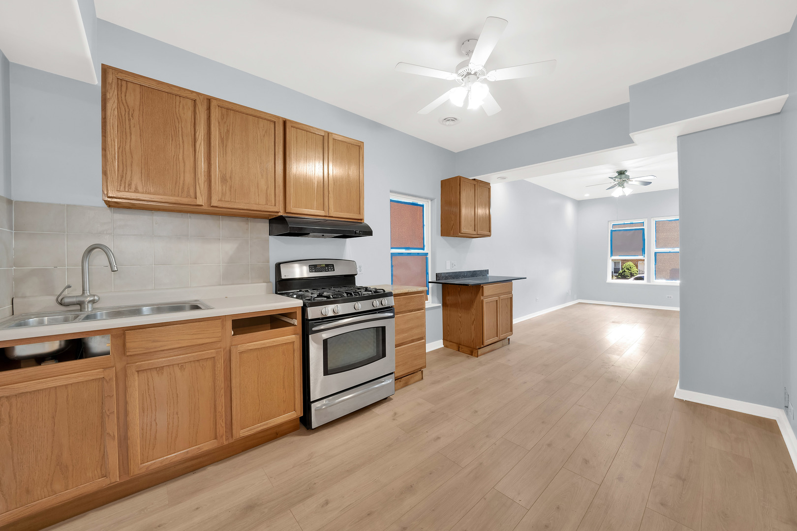 3826 South Honore Street Chicago, IL 60609 - Photo 16 of 19 a kitchen with cabinets a sink and stainless steel appliances