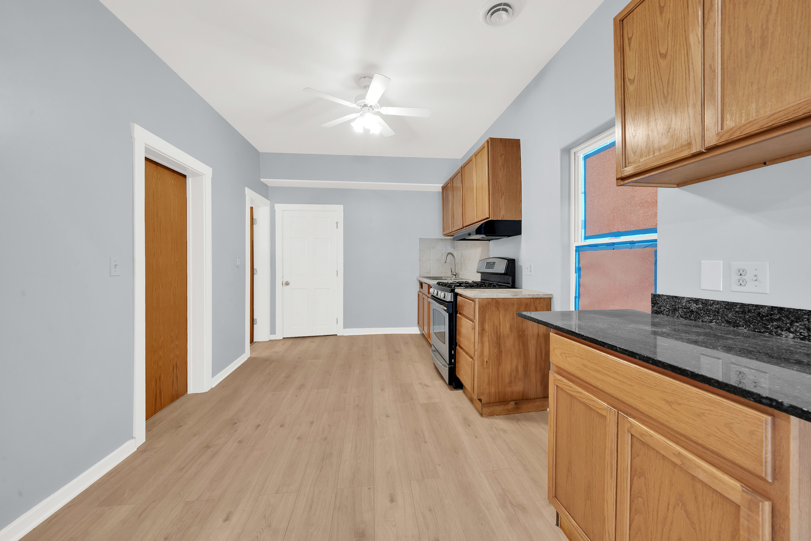 3826 South Honore Street Chicago, IL 60609 - Photo 17 of 19 a kitchen with granite countertop a sink stainless steel appliances and cabinets