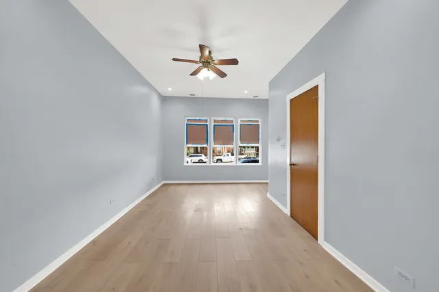 a view of a big room with wooden floor closet and windows