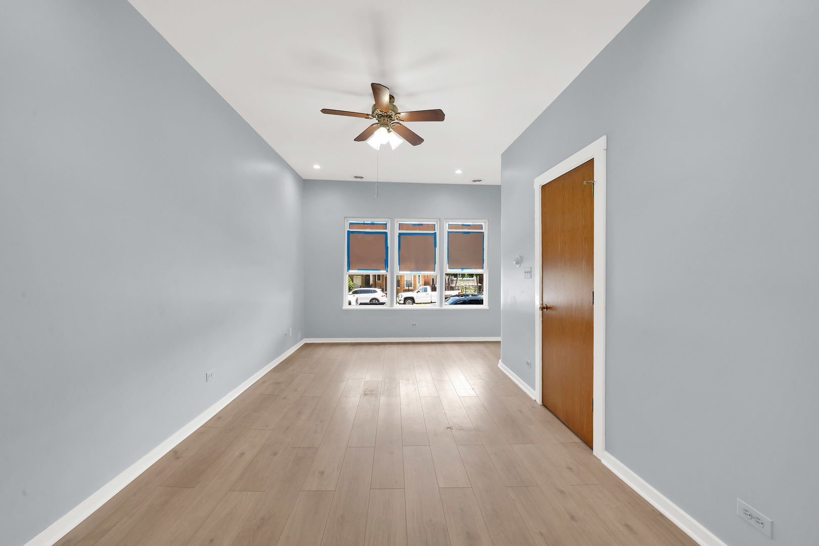 3826 South Honore Street Chicago, IL 60609 - Photo 18 of 19 a view of a big room with wooden floor closet and windows