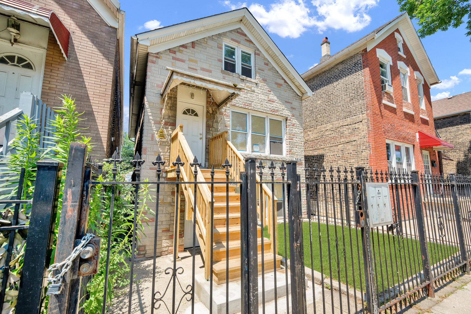 3826 South Honore Street Chicago, IL 60609 - Photo 3 of 19 a front view of a house with a garden