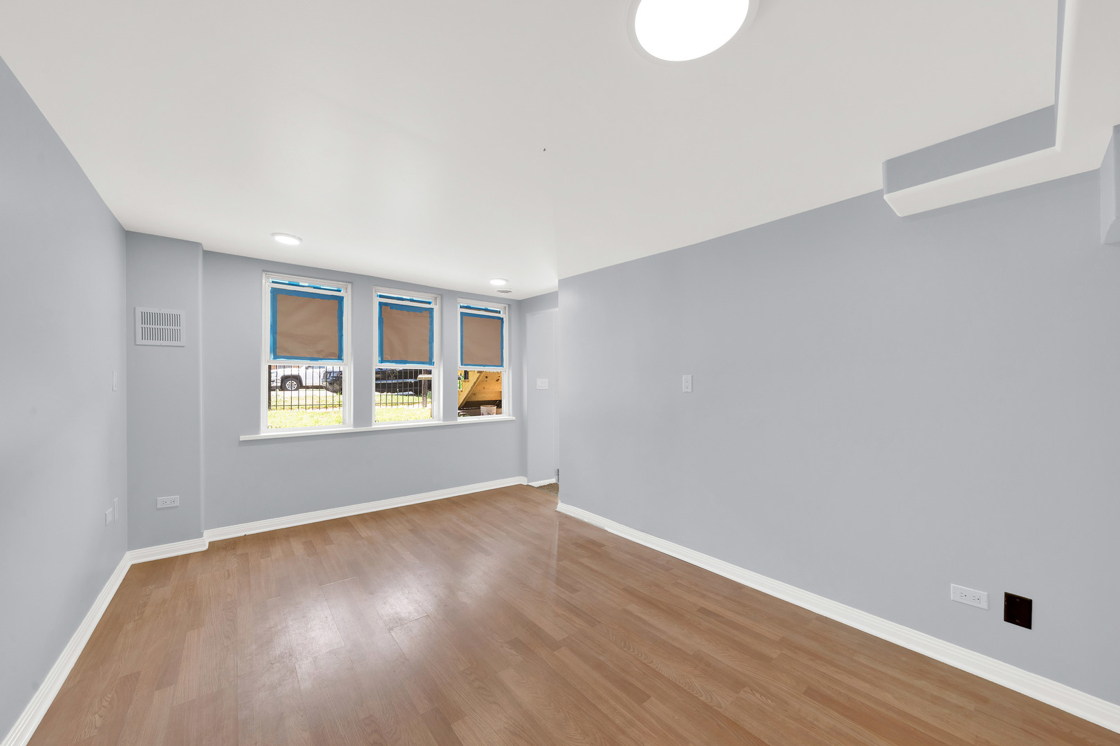 3826 South Honore Street Chicago, IL 60609 - Photo 4 of 19 a view of an empty room with wooden floor and a window