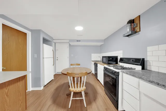 a kitchen with a stove a sink and a refrigerator