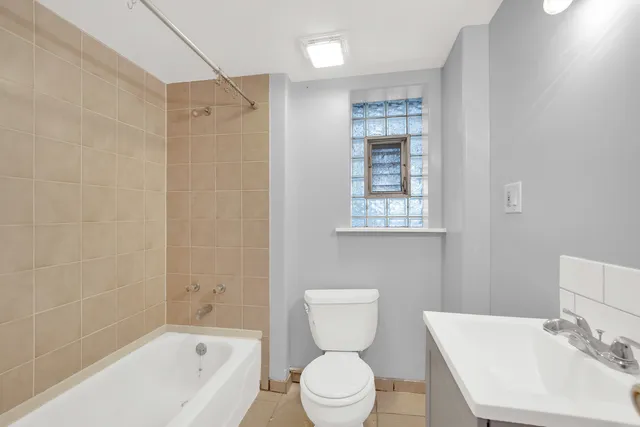 a bathroom with a toilet a sink and a bathtub