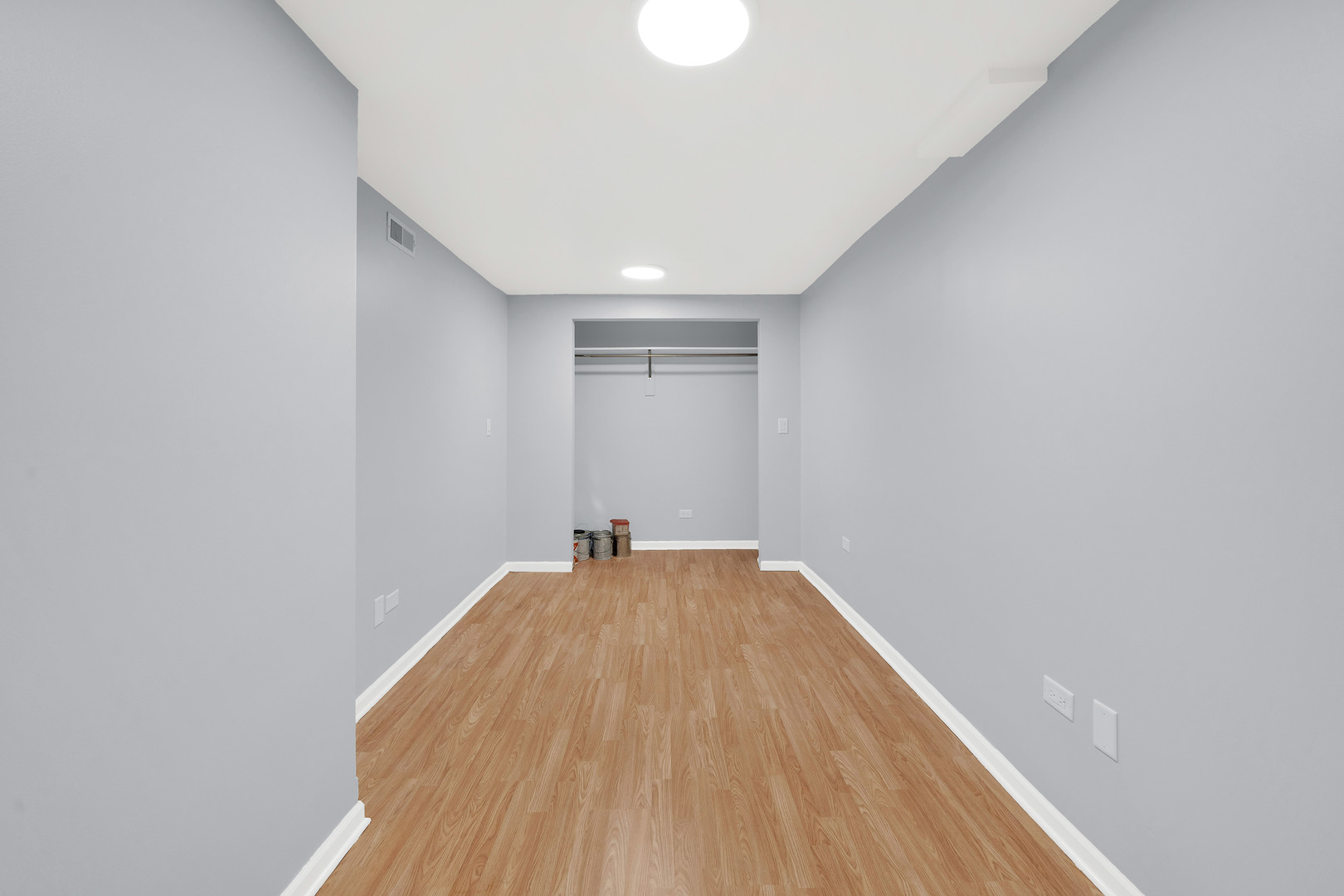 3826 South Honore Street Chicago, IL 60609 - Photo 9 of 19 a view of a big room with wooden floor and fan