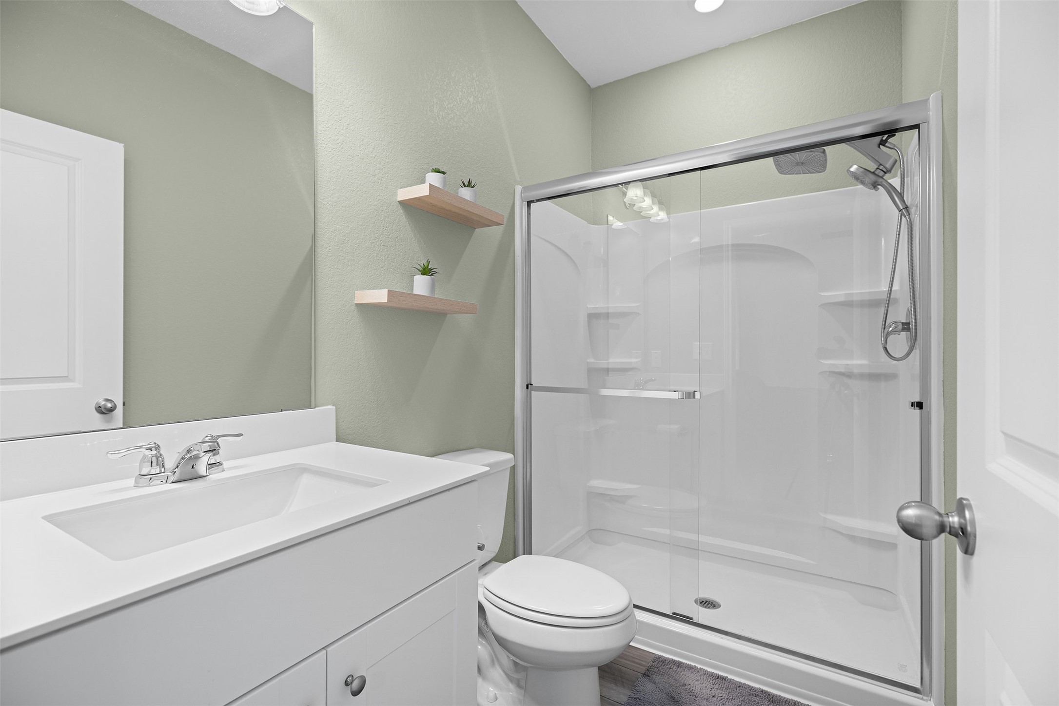 104 Enforcer Loop Jarrell, TX 76537 - Photo 7 of 12 a bathroom with a sink toilet and shower