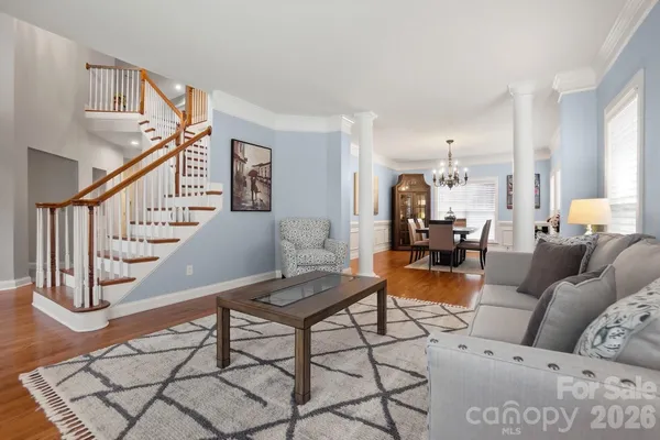 a living room with furniture and wooden floor