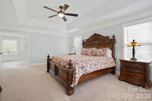 a spacious bathroom with a tub sink and mirror