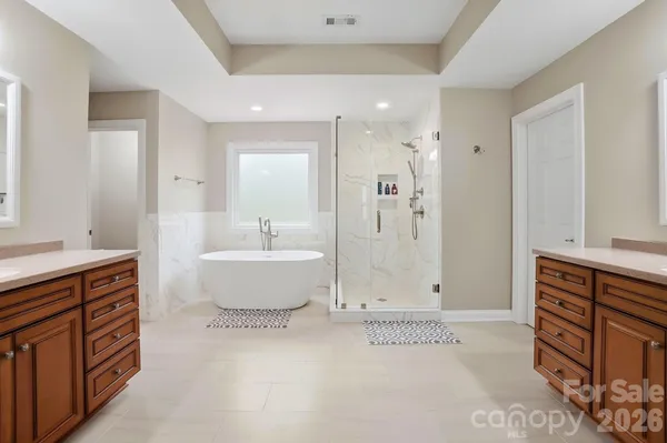 a bathroom with a bathtub and shower