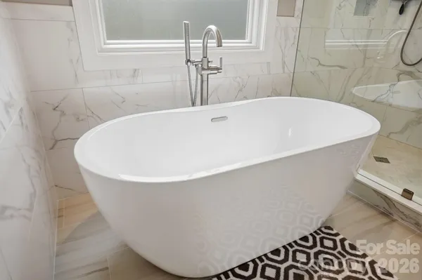 a spacious bathroom with a granite countertop sink and mirror