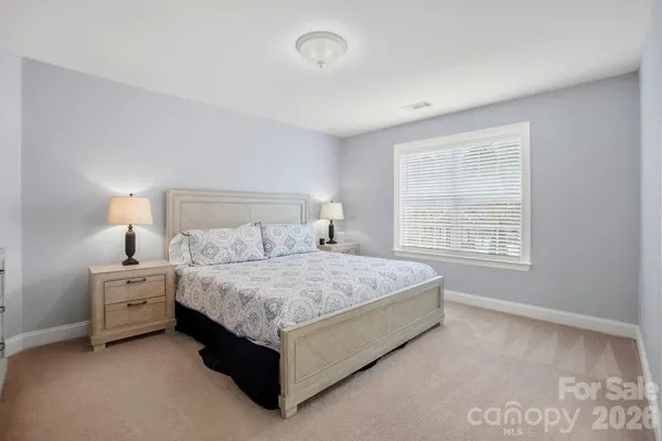 a bedroom with a bed and a lamp