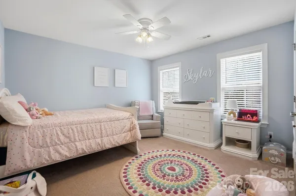 a bedroom with a bed couch and a window