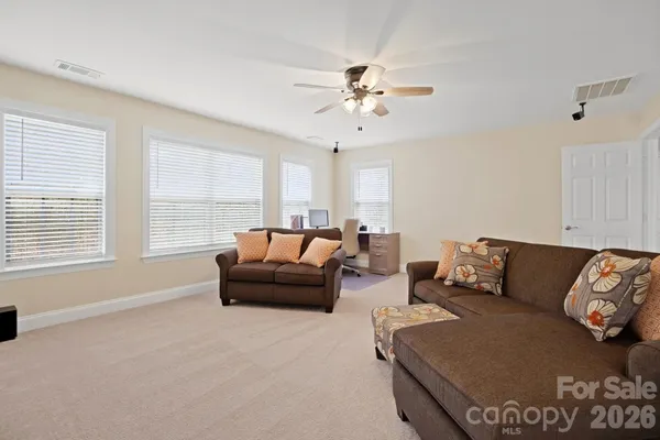 a front view of a house with yard and trees