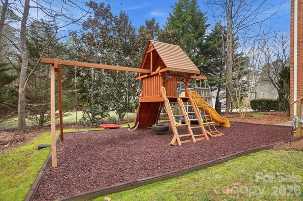 a view of a deck with wooden floor and a yard