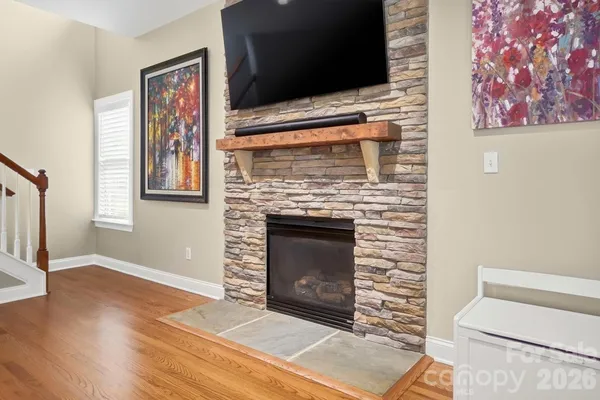 a living room with a fireplace and a flat screen tv