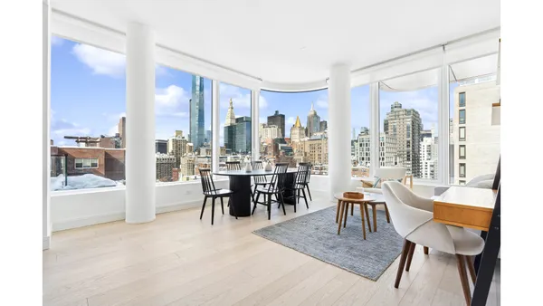 a view of a dining room with furniture and chandelier