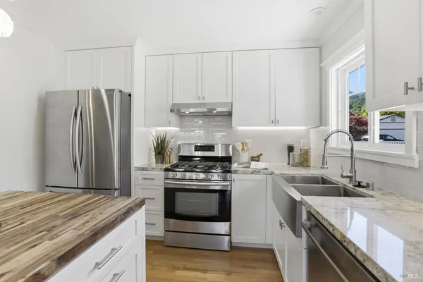 a kitchen with a stove sink and refrigerator