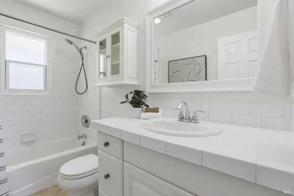 a bathroom with a sink a toilet and a tub