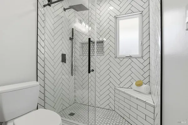 a bathroom with a toilet and a shower