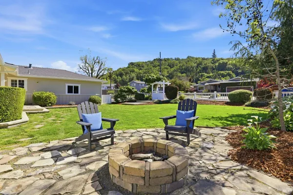 a view of a house with backyard sitting area and garden