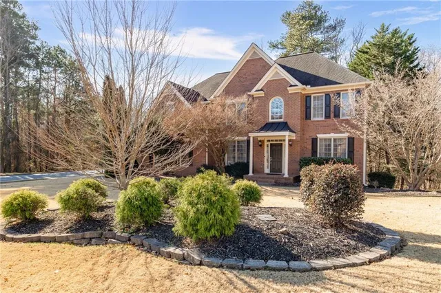 a front view of a house with a yard