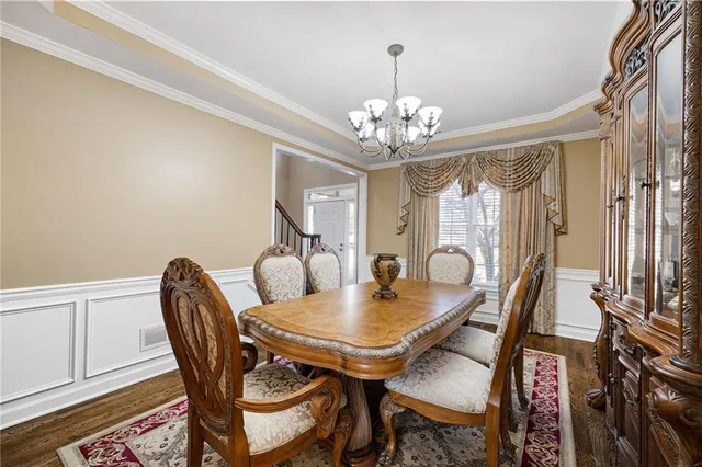 a living room with furniture a fireplace and a large window
