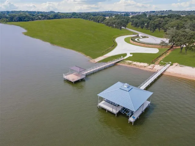 an aerial view of a house with a lake view