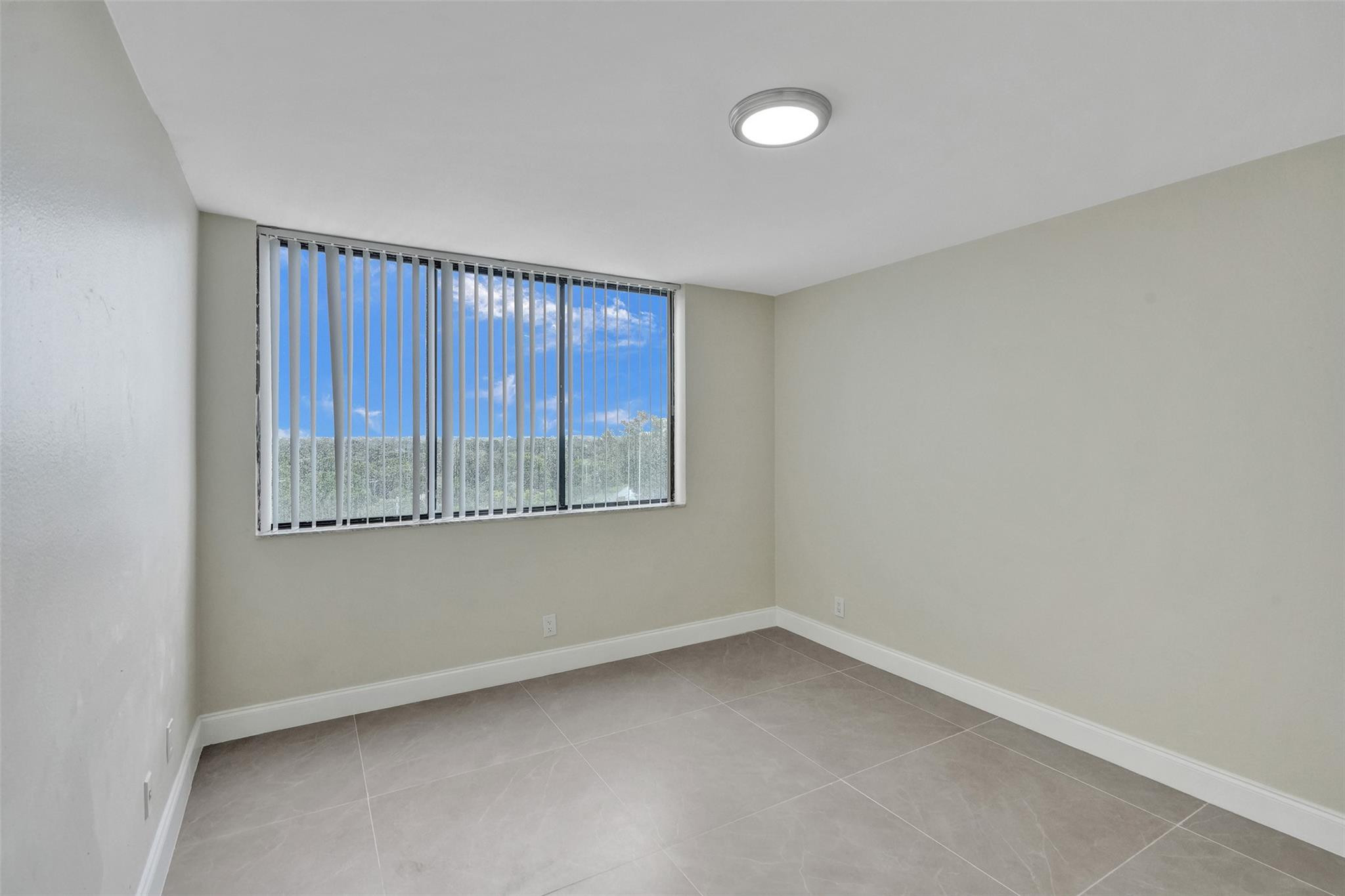 4222 Inverrary Boulevard, Unit 4810 Lauderhill, FL 33319 - Photo 44 of 63 an empty room with windows