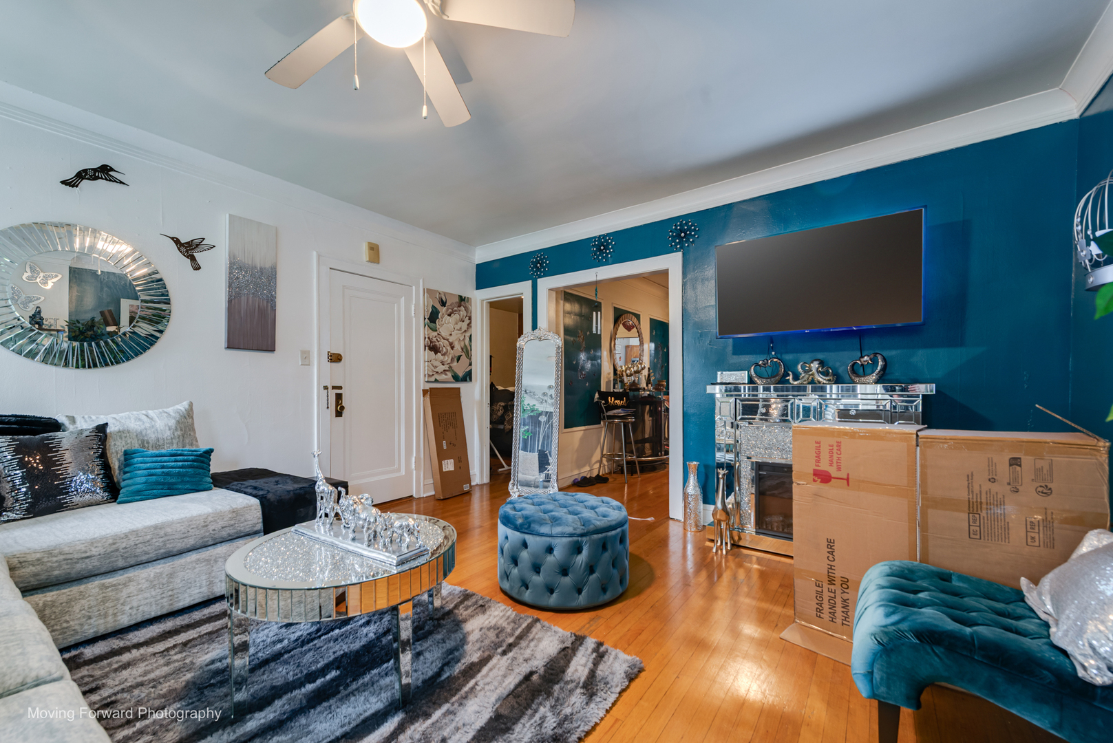 8213 South Indiana Avenue Chicago, IL 60619 - Photo 13 of 25 a living room with furniture and a flat screen tv