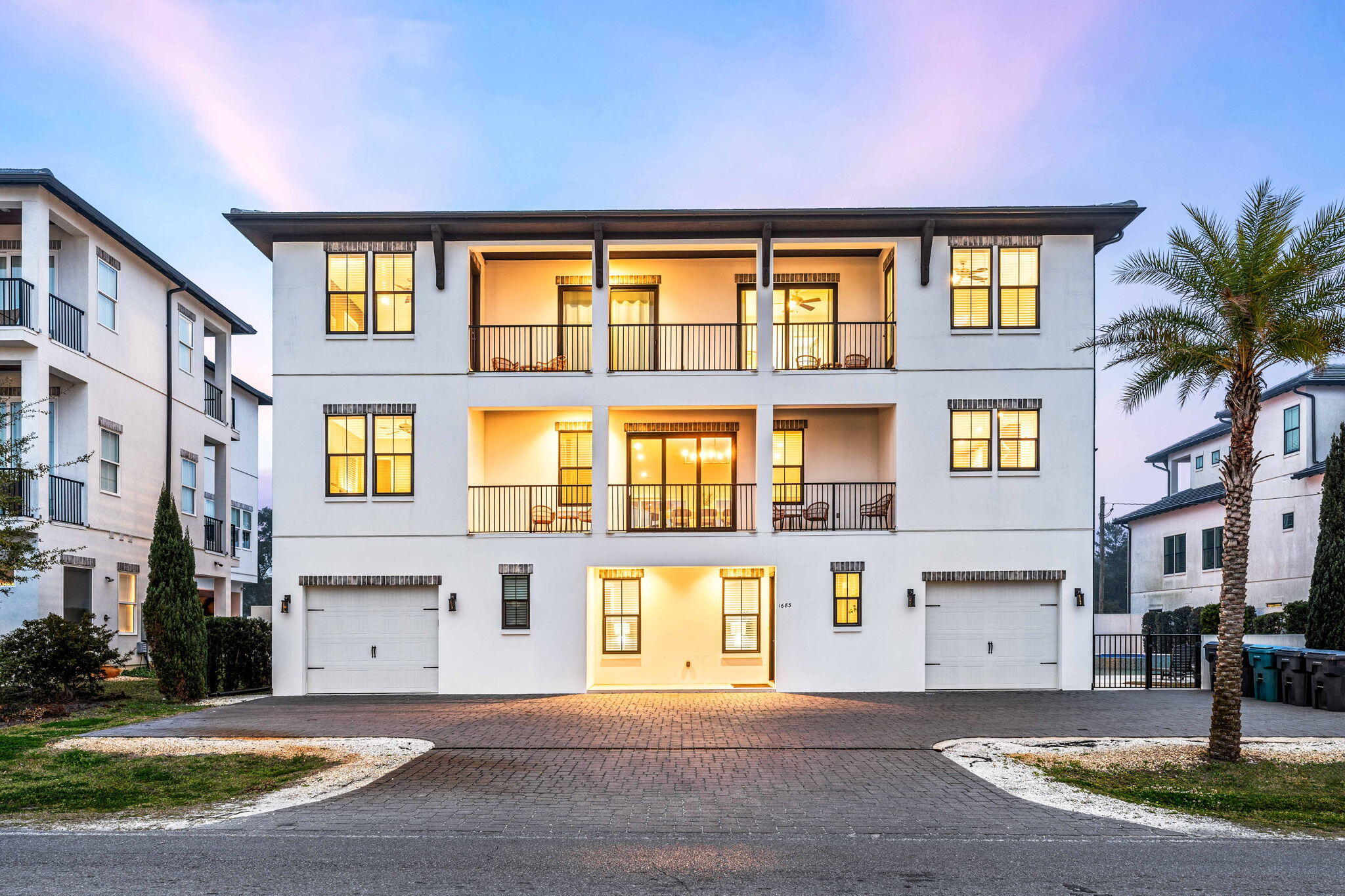 a front view of a building with a garden