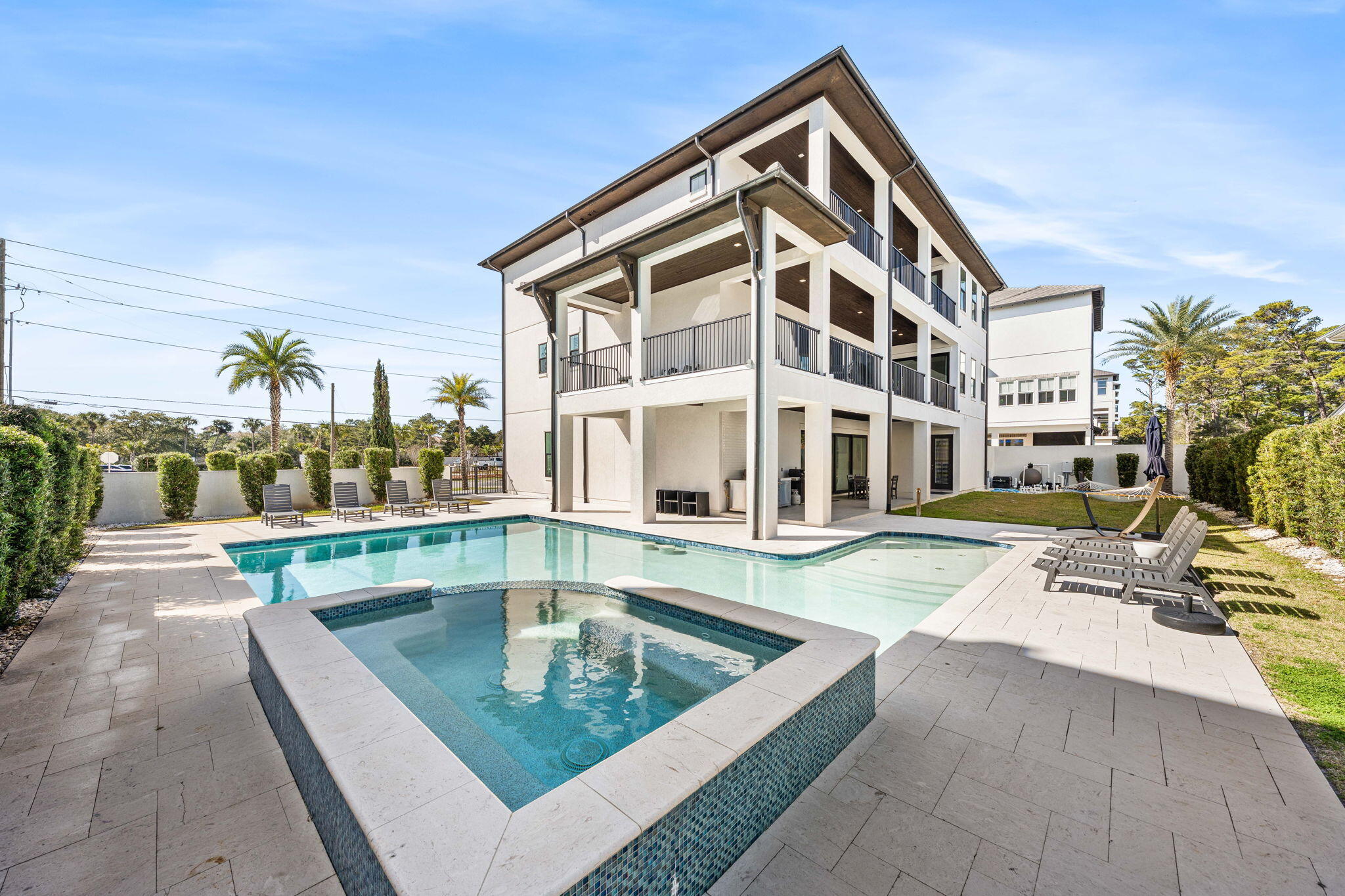 1683 South Co Highway 393 Santa Rosa Beach, FL 32459 - Photo 18 of 72 a view of swimming pool with outdoor seating and house in the background