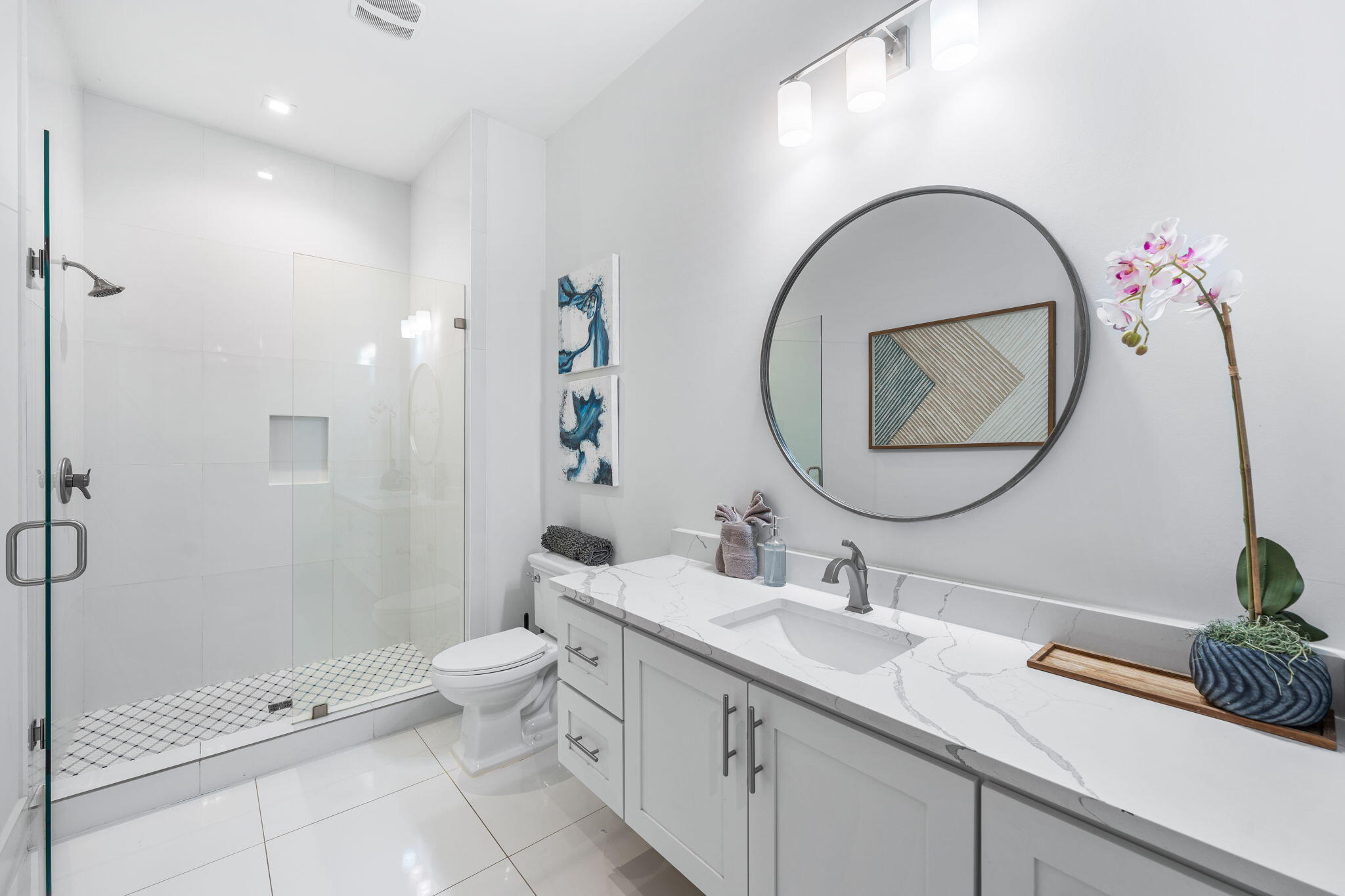 1683 South Co Highway 393 Santa Rosa Beach, FL 32459 - Photo 26 of 72 a bathroom with a double vanity sink toilet mirror and shower