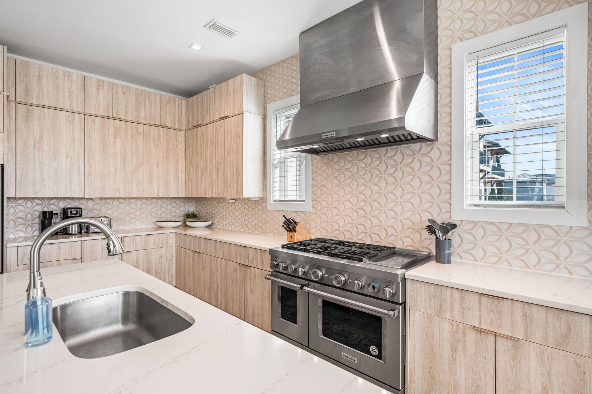 1683 South Co Highway 393 Santa Rosa Beach, FL 32459 - Photo 38 of 72 a kitchen with stainless steel appliances a sink a stove and cabinets