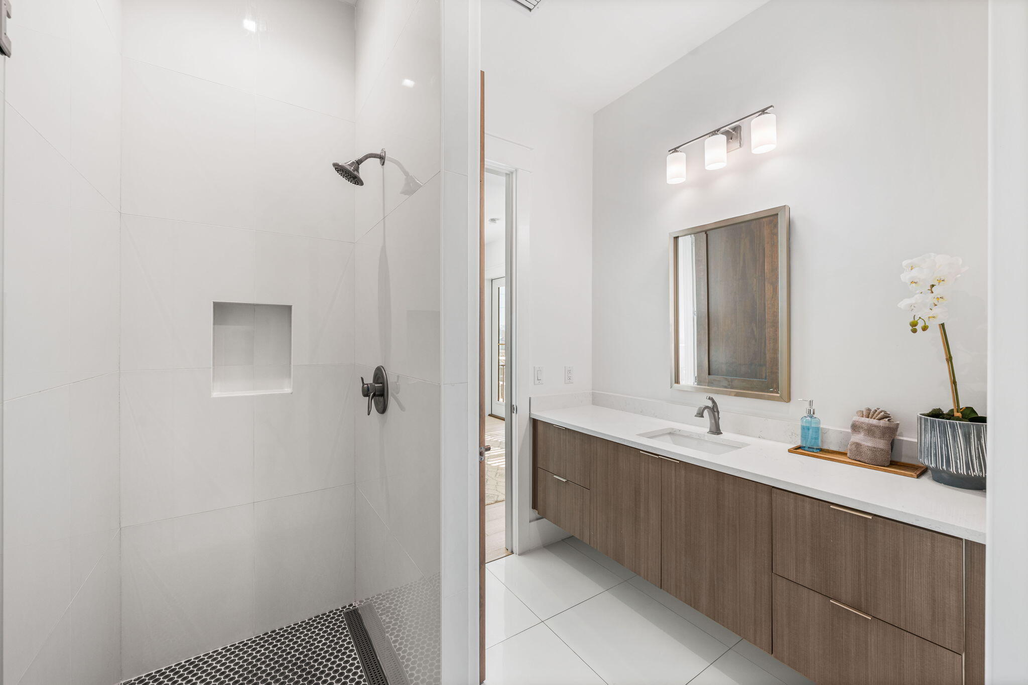 1683 South Co Highway 393 Santa Rosa Beach, FL 32459 - Photo 50 of 72 a bathroom with a double vanity sink a mirror and a shower