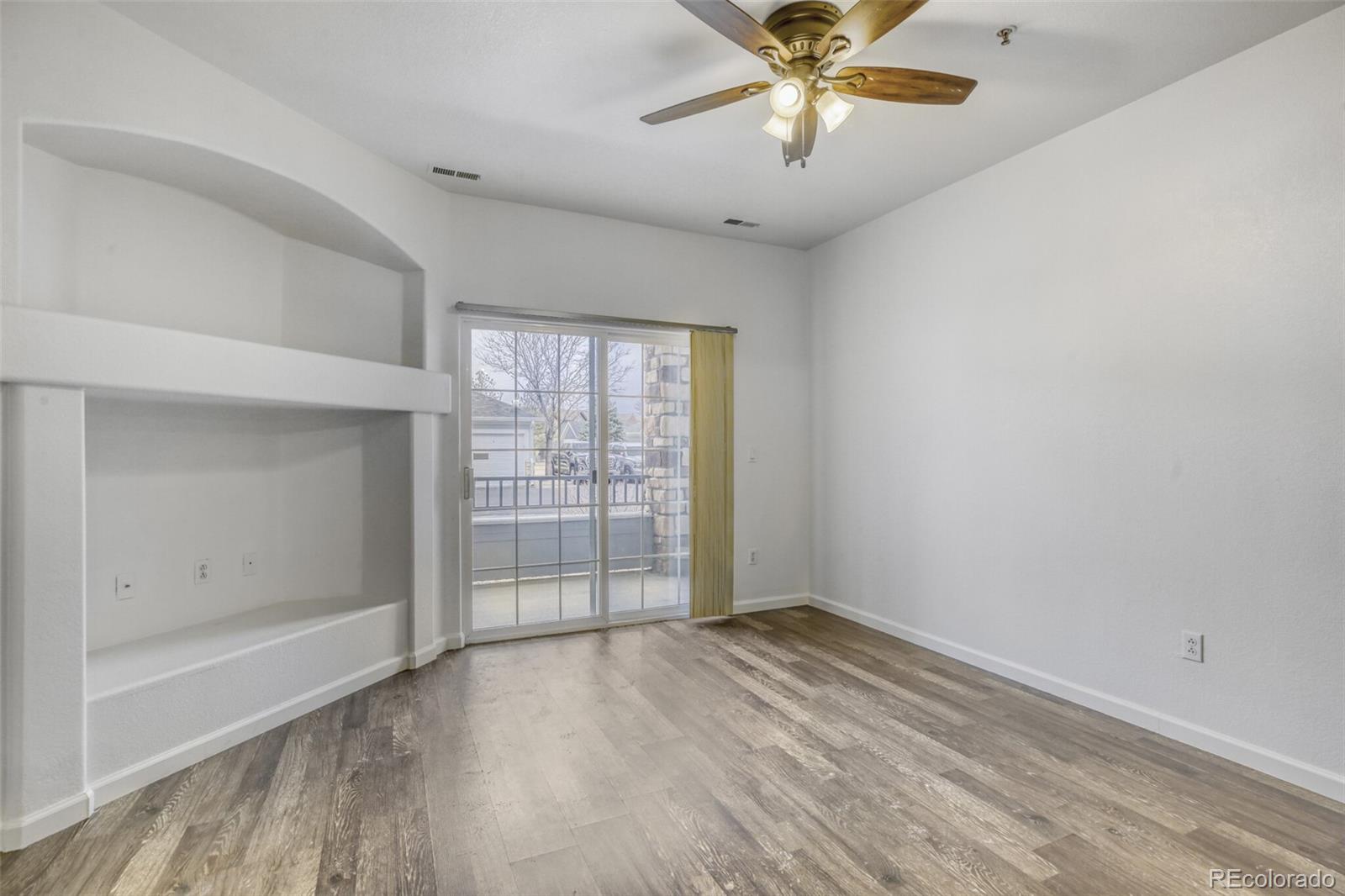 5255 Memphis Street, Unit 207 Denver, CO 80239 - Photo 11 of 21 wooden floor in an empty room with a window