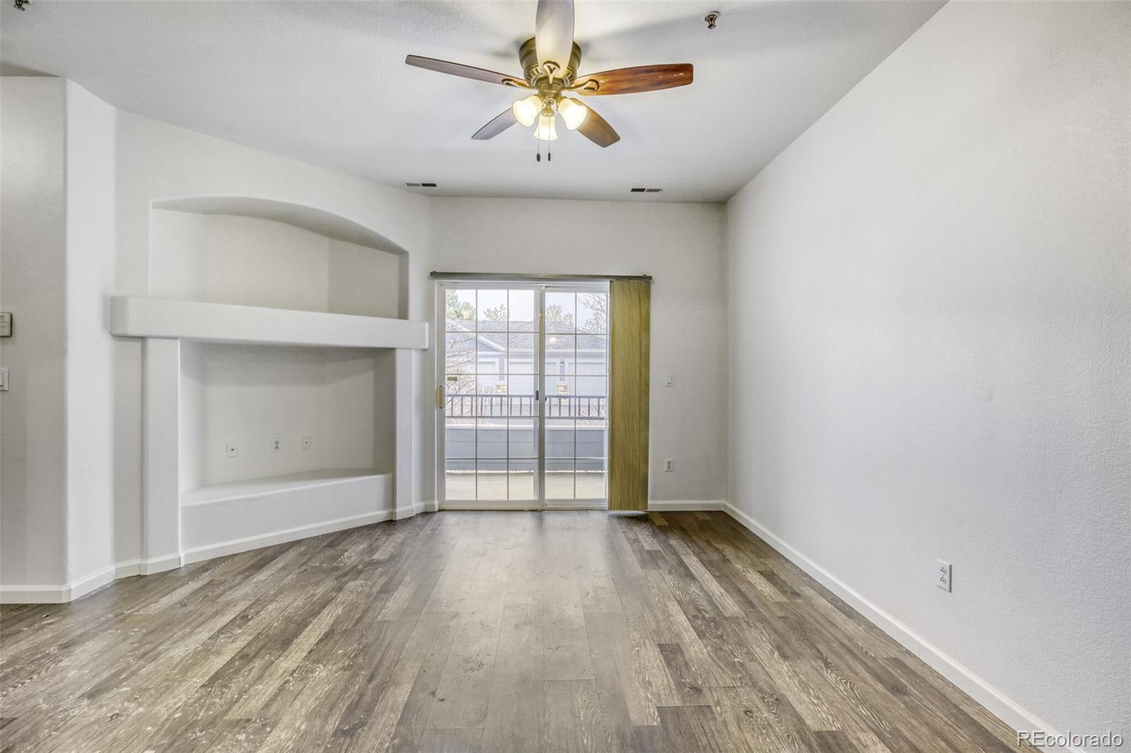 5255 Memphis Street, Unit 207 Denver, CO 80239 - Photo 12 of 21 wooden floor in an empty room with a window