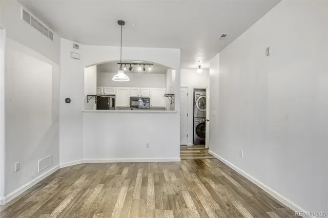 a view of a kitchen with a sink and dishwasher wooden floor