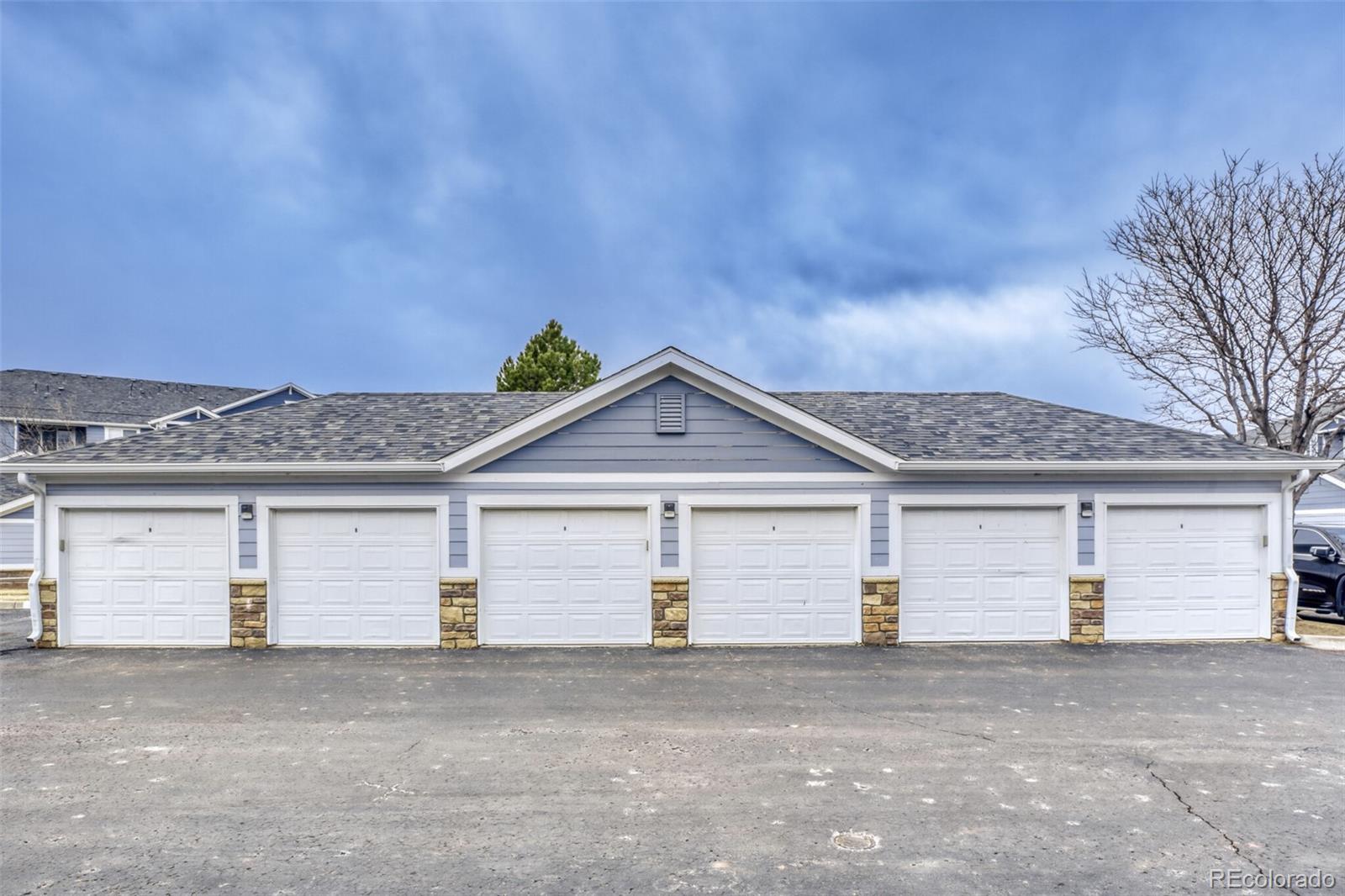 5255 Memphis Street, Unit 207 Denver, CO 80239 - Photo 19 of 21 a front view of a house with a garage and a garage